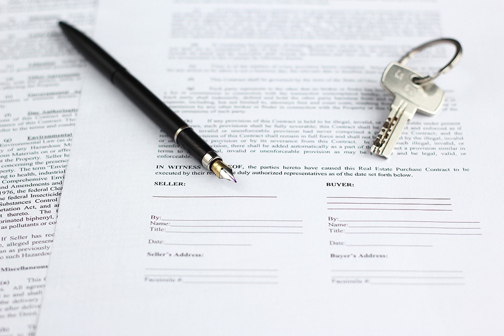 Real estate attorney in Naples, Florida reviewing closing documents with clients during a residential property transaction.