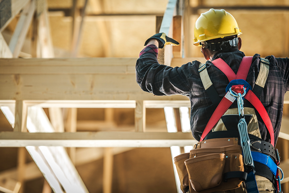 Florida construction law attorney reviewing building plans with a contractor to resolve disputes over defects, contracts, and liability.